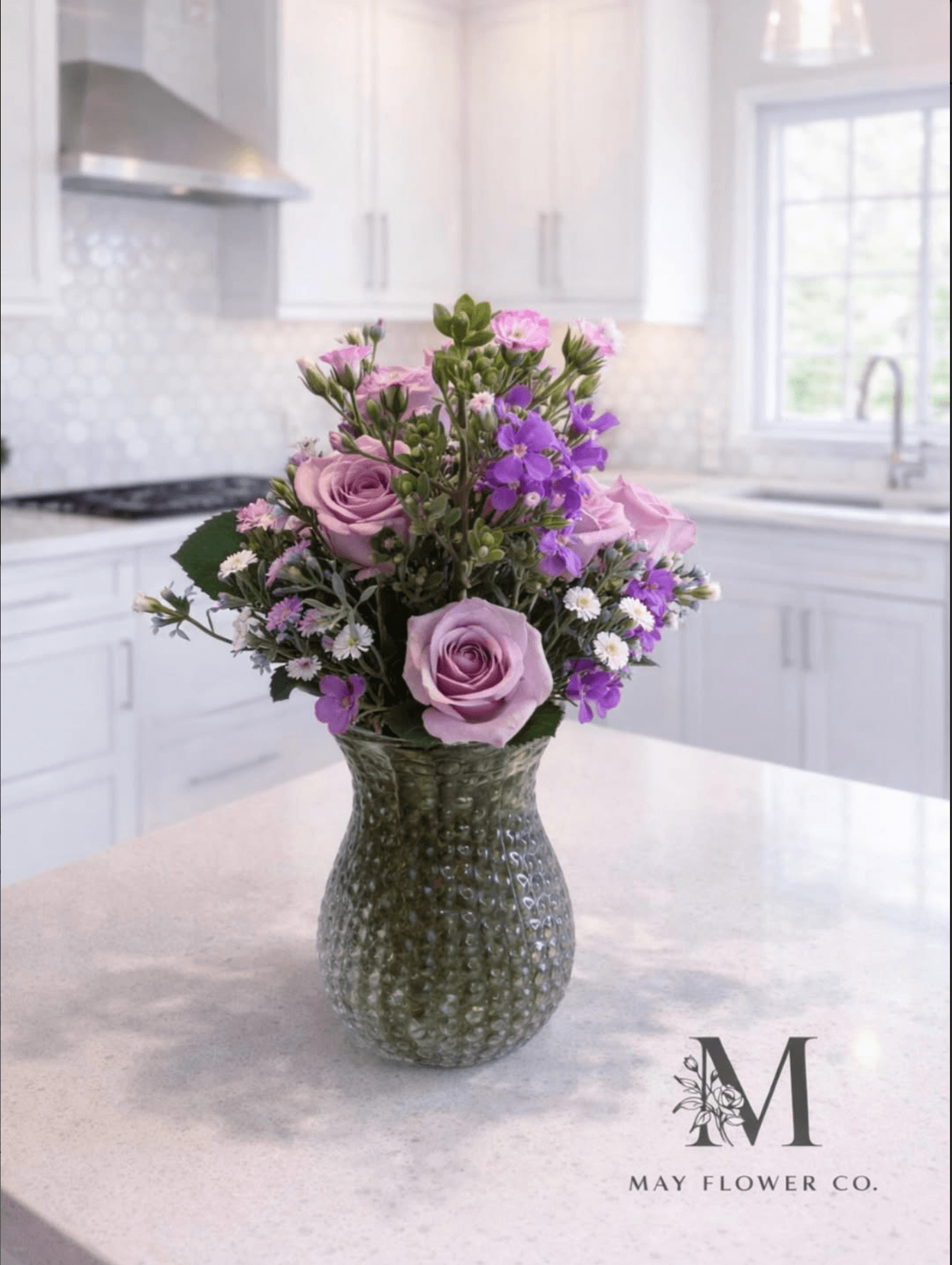 A purple-and-rose composition in a textured ceramic vessel.