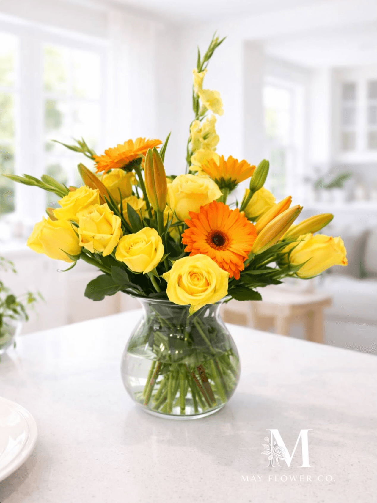 A bright yellow-and-orange arrangement on a marble counter.